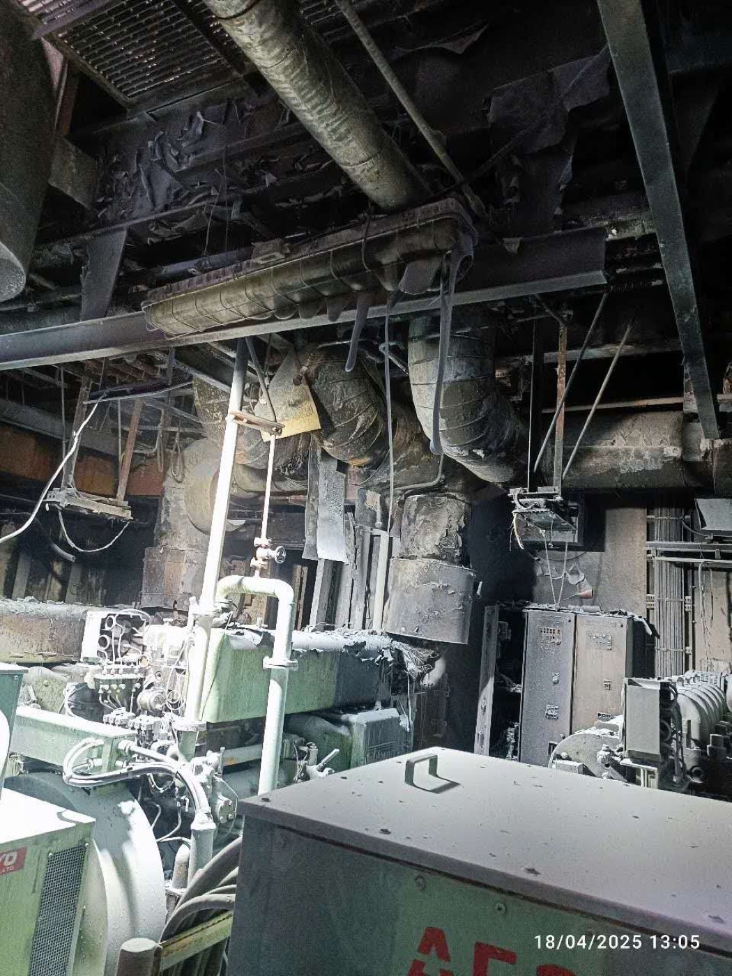 Soot-blackened machinery and overhead services after the fire
