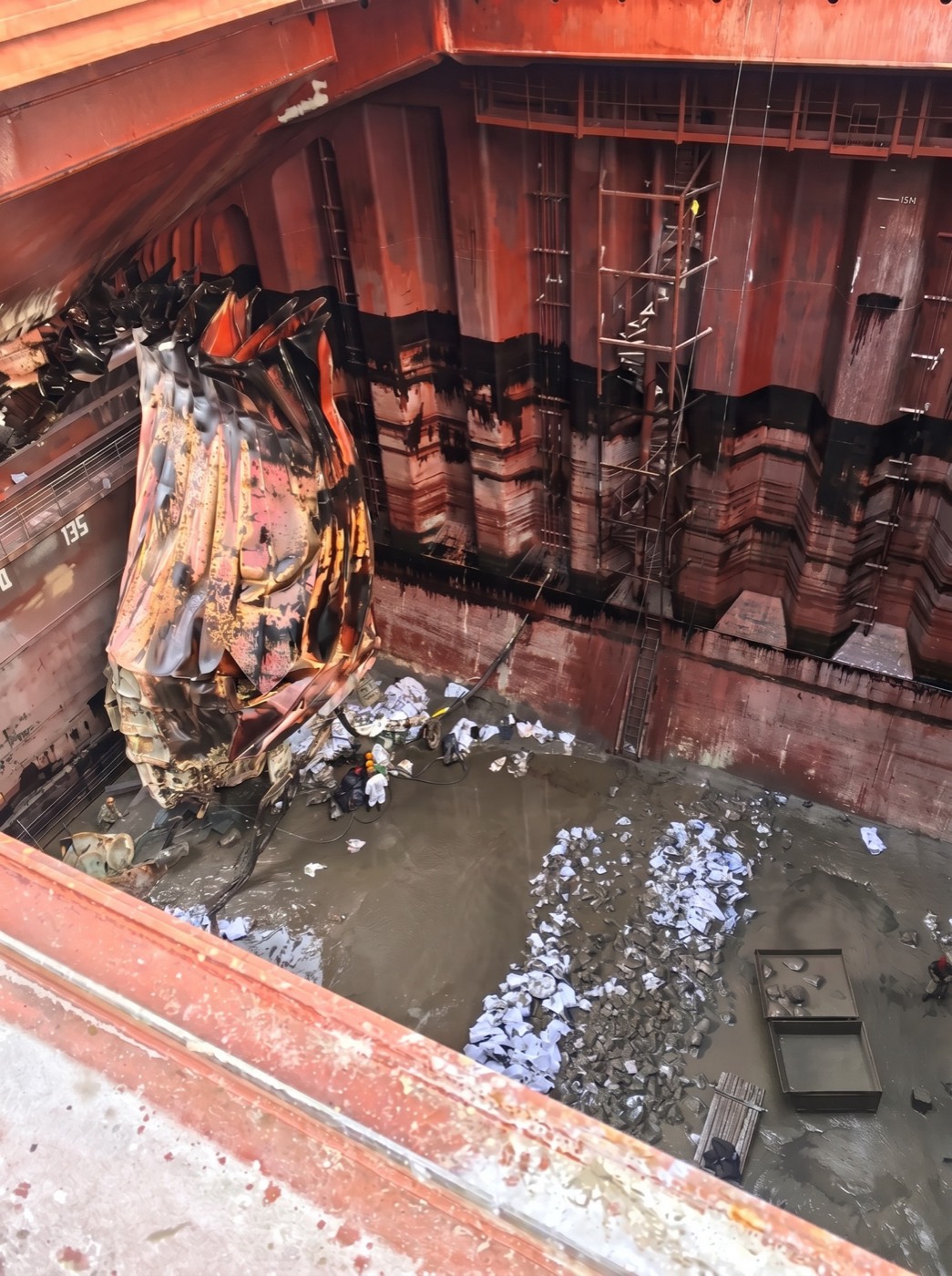 Torn steel and debris inside the flooded cargo hold
